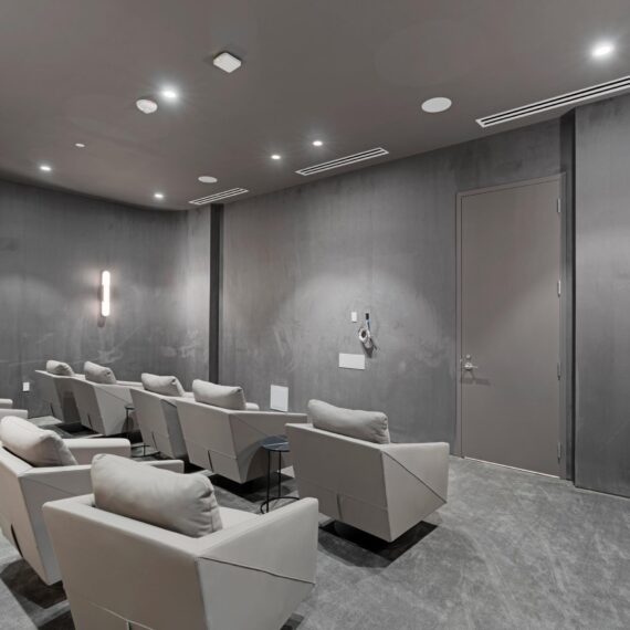 La Clara Palm Beach theater room featuring custom angular leather lounge chairs manufactured by A Squared Design Studio.