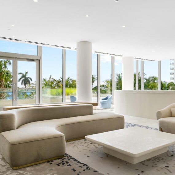 Modern coastal lobby at La Clara Palm Beach featuring custom sculpted seating and tables by A Squared Design Studio.